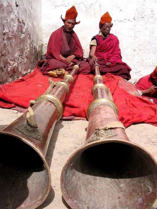 Monks playing long trumpets at the Karsha festival in Zanskar
