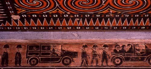 Carving on a Toraja house depicting scene from owner's millitary service